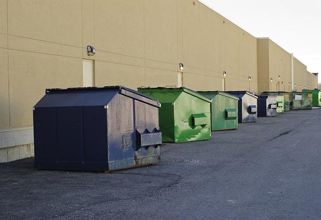 metal waste containers sit at a busy construction site in Aledo